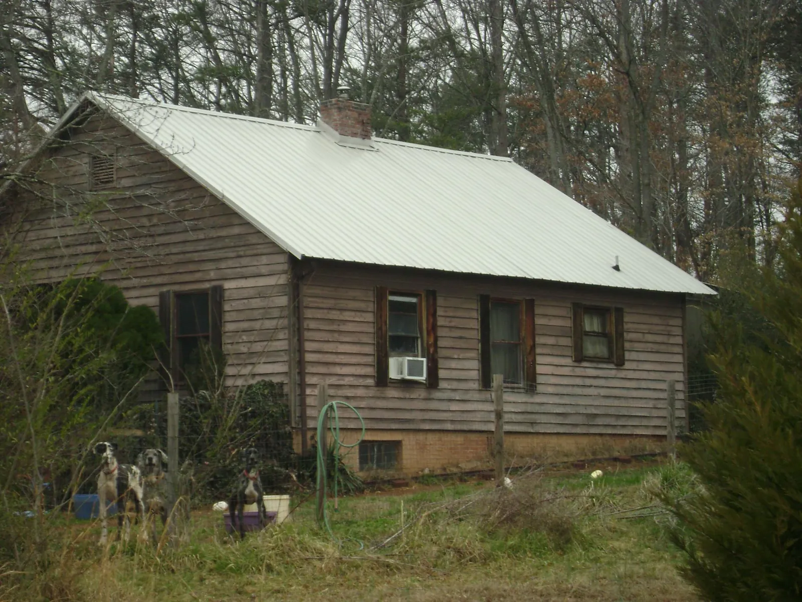 White metal roof on an old wood sided farmhouse, from a Metal Roof Installation job in Clarissa